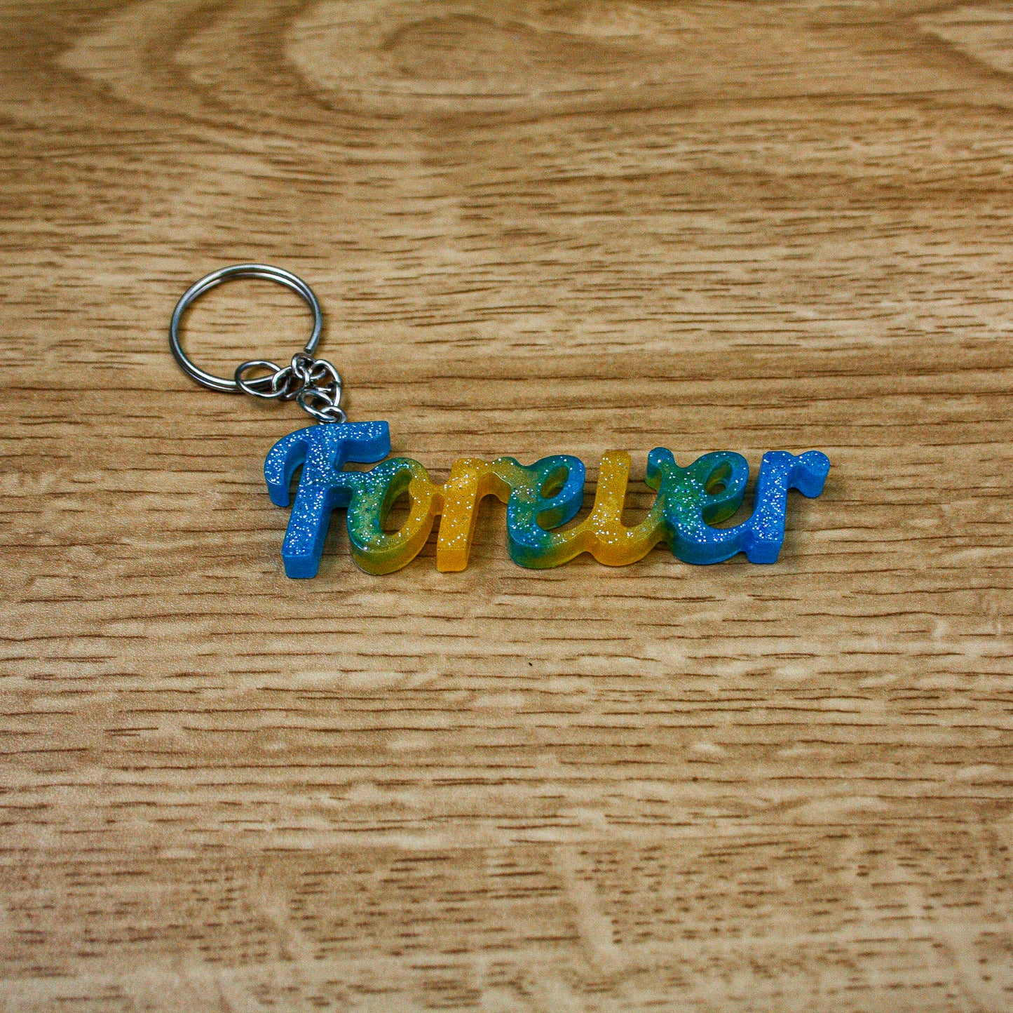 Porte clés " forever " bleu jaune paillettes