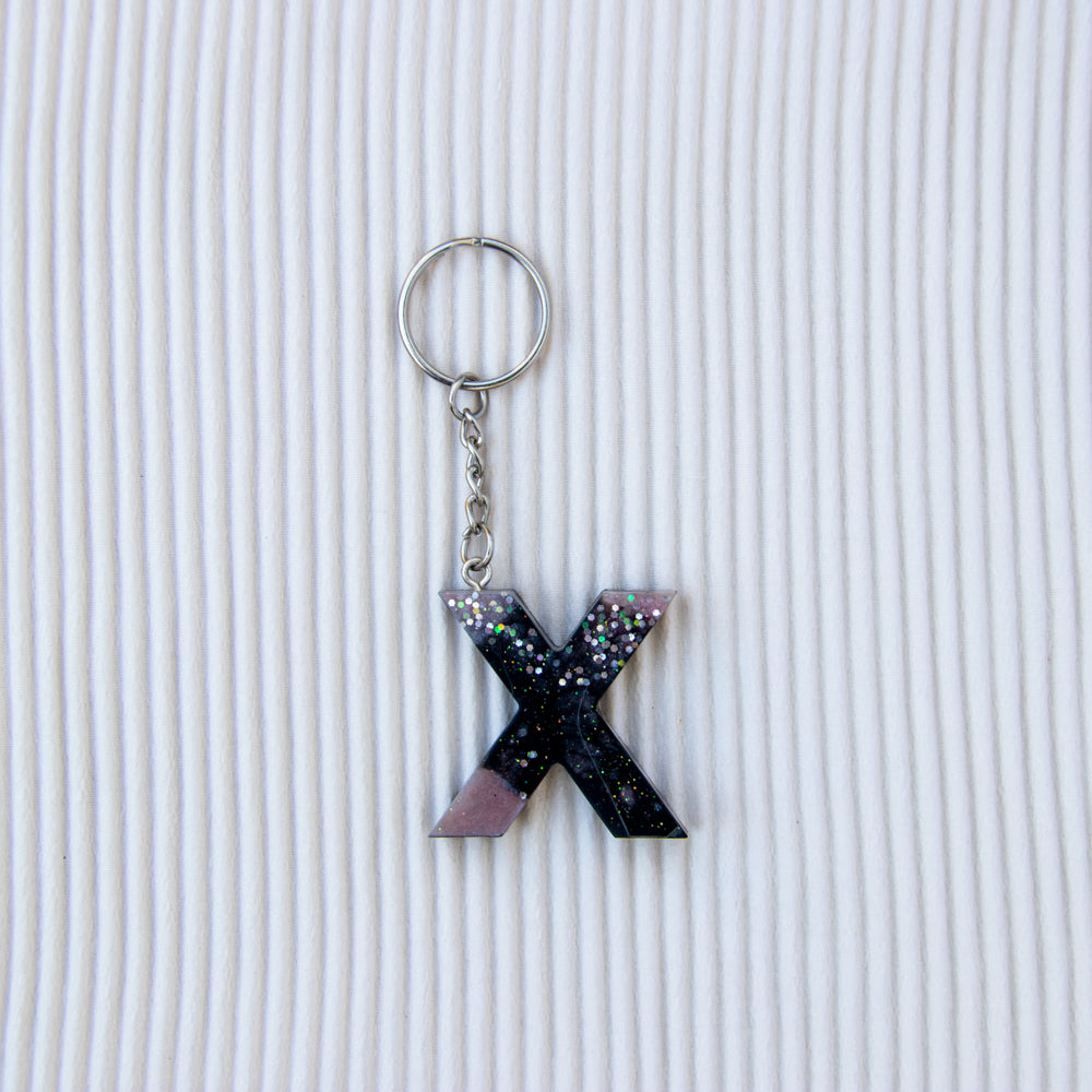 Porte-clés lettre X noir mauve paillettes