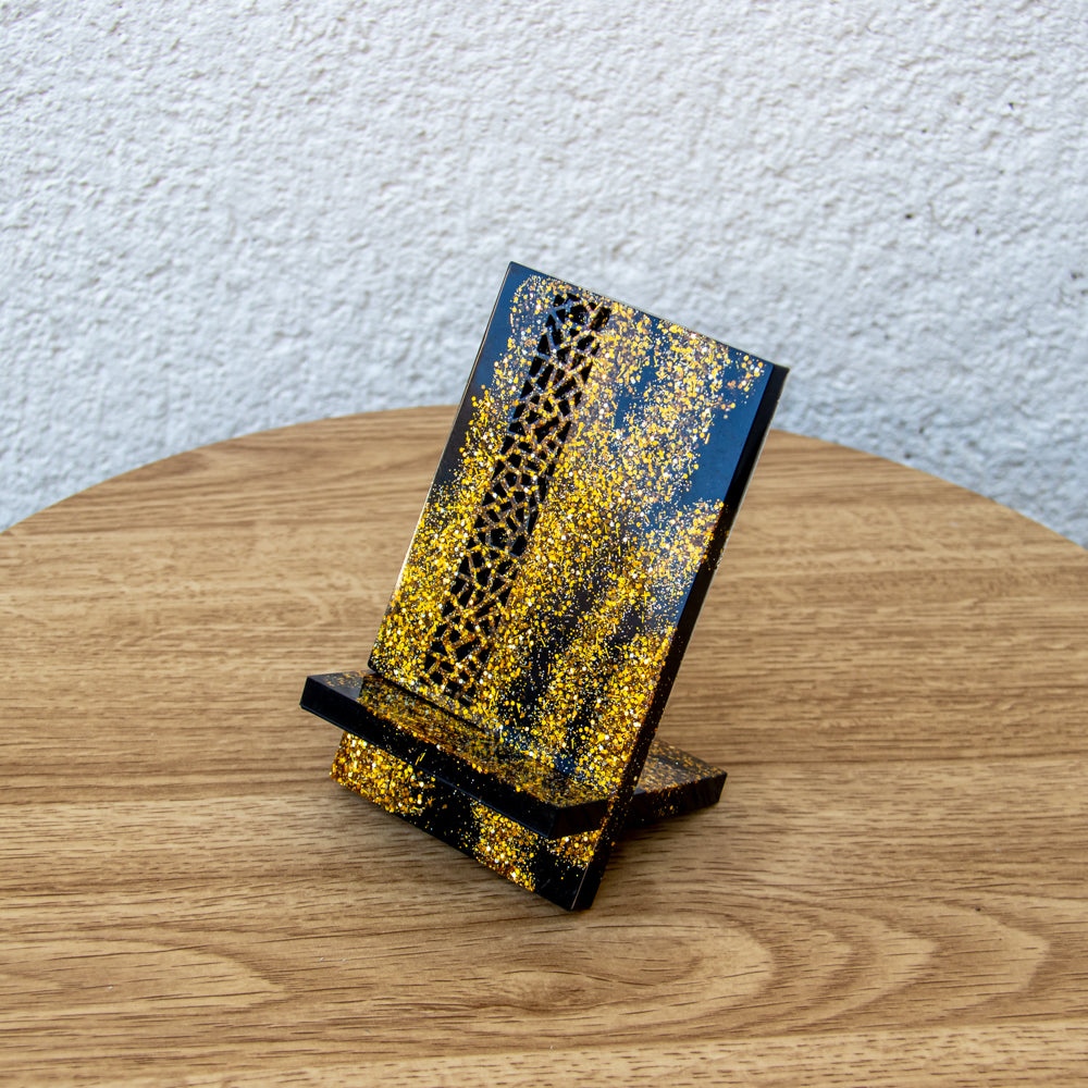 Support téléphone avec motif noir et paillettes or