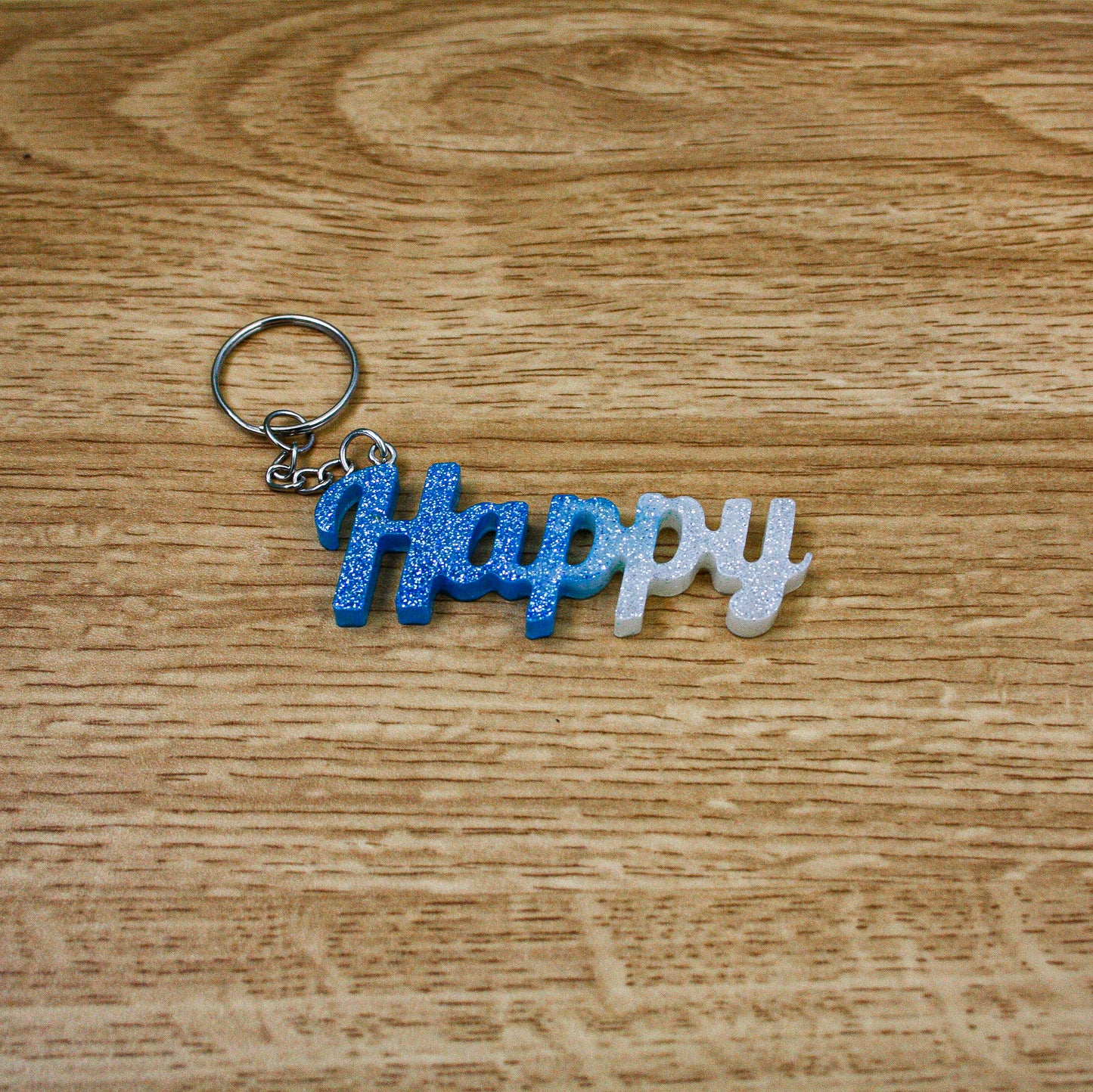 Porte clés " happy " bleu blanc paillettes